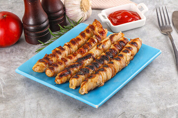 Grilled meat sausages wrapped bacon