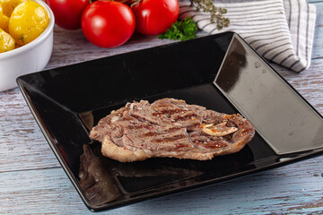 Grilled lamb steak with bone