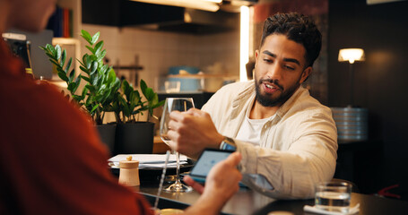 Happy man, customer and bartender with watch on pos machine for payment or wireless transaction....