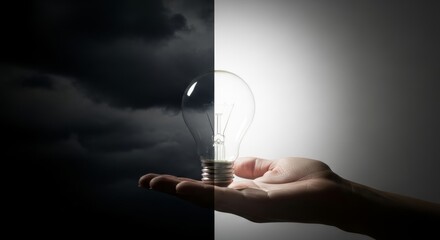Lightbulb held in hand splitting a black and white scene idea imagination hand power inspiration concept creation