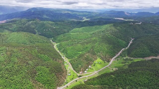 Aerial view of forested valleys under clouds