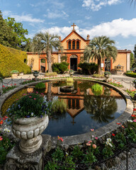 Colorful chapel of Isola Madre reflecting into the fountain, Lake Maggiore, Piedmont, Italy,