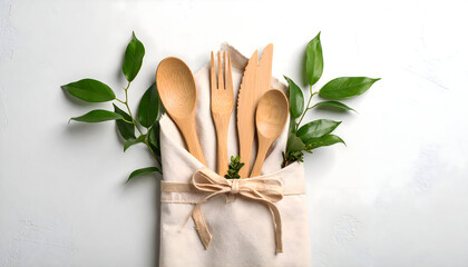 Eco-Friendly Wooden Cutlery Set with Greenery, Tied in a Linen Pouch, White Background.