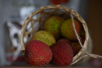 close up lychees in a basket falling