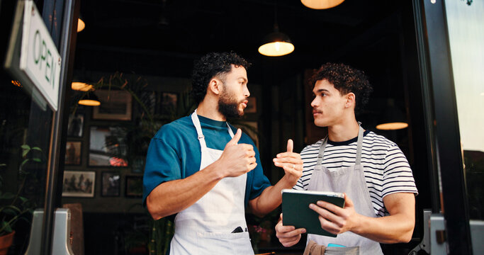 Tablet, conversation and people in cafe, employees and hospitality with help, menu items or teaching. Business, cooperation or men in restaurant, tech or digital app for online order, support or talk - Powered by Adobe