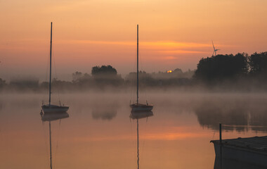 Naklejka premium Sunrise over the lake. Sunny June morning.