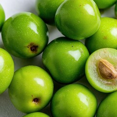 Obraz premium Close-Up of Fresh Green Jujube Fruits with Seed on White Background