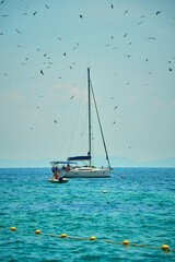 a beautiful yacht sails along the azure bay
