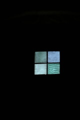 colored window in the dark blue green