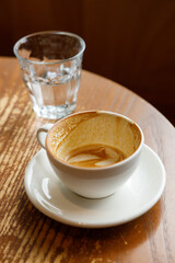 Empty cup of hot milk latte coffee on table by the window.