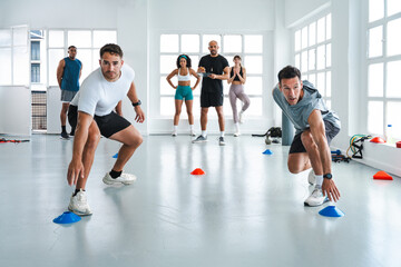 Multiethnic group of sportive people doing functional workout at the gym, concepts about sport and...