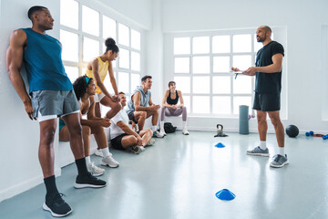 Multiethnic group of sportive people doing functional workout at the gym, concepts about sport and...