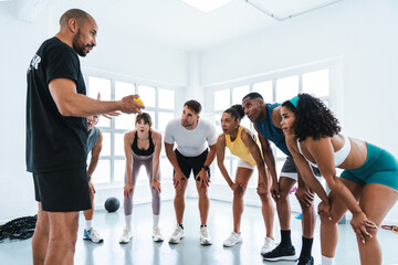Multiethnic group of sportive people doing functional workout at the gym, concepts about sport and...