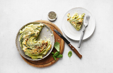 Vegetable zucchini round pie with pies on the ceramic plate on white background, top view