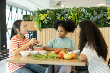 group of multi-ethnic children girls are learning how to cooking with miniature kitchen utensils, teamwork student education up skill make food.
