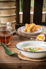 Rice porridge or pork congee for breakfast, boiled eggs, fried dough sticks, traditional coffee, soft-boiled eggs