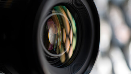 A closeup shot captures the intricate details and colorful reflections within a camera lens
