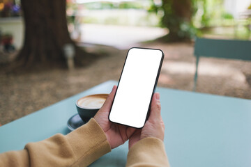 Mockup image of a woman holding mobile phone with blank screen in the outdoors