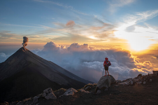 One person looking Volc&aacute;n de Fuego eruption at sunset
