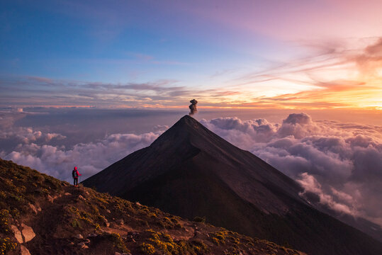 One person on a trail at Volc&aacute;n de Fuego smoking at sunset