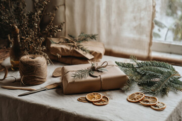 Rustic eco gift wrap scene with brown paper, pine sprigs, citrus slices, and twine on a cozy table in soft window light, perfect for sustainable holidays.