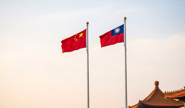 Taiwanese flag with Chinese flag side by side with sunset background and in the iconic building area