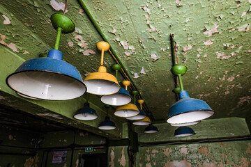 Abandoned Industrial Lights on Peeling Walls