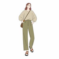 Woman in sage green high-waisted pants and oversized beige sweater with a sling bag. A cozy, stylish everyday outfit for fashion editorial and lifestyle visuals.