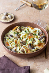 Fettuccine pasta with chicken and mushrooms in creamy sauce. Italian cuisine. Recipe.