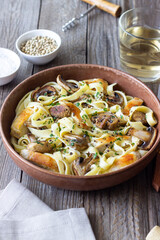 Fettuccine pasta with chicken and mushrooms in creamy sauce. Italian cuisine. Recipe.