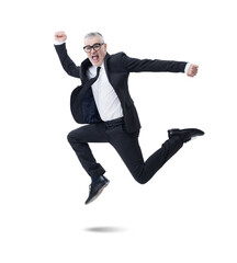 A businessman in a dark suit, jumps joyfully as he celebrates his success.