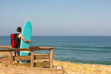 Surfer looking at the ocean before entering the water