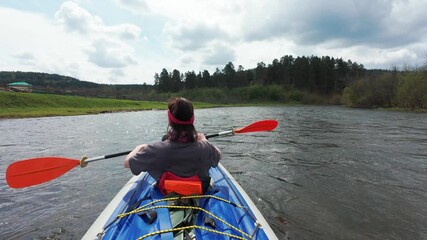 Experience tranquility kayaking on a calm river, surrounded by lush greenery and scenic views. Perfect for adventure enthusiasts and nature lovers seeking a peaceful escape outdoors