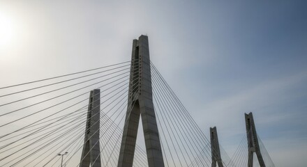 Fototapeta premium Modern cable-stayed bridge towers under a bright sky