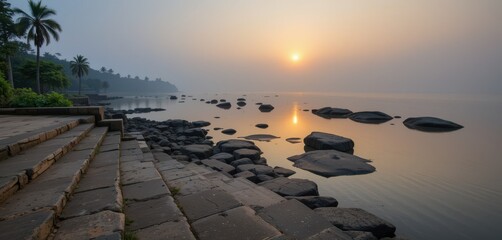Serene morning landscape featuring golden sunlight reflecting on the water, with rocks and stone steps along the shore, creating an atmosphere of calm beauty and new beginnings.