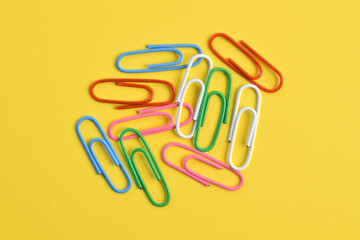 Paper clips isolated on yellow background