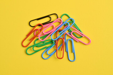 Paper clips isolated on yellow background