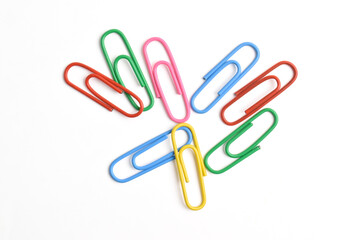 Many colorful paper clips isolated on white background, top view