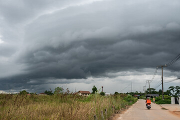 An arcus cloud appear on the sky. Arcus clouds are spectacular low-level, long and thin clouds associated with powerful thunderstorms.