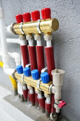 Distribution manifold  , direct and return lines, with copper collector and red  pipes