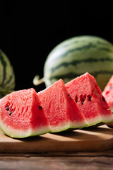 fresh ripe sliced watermelon fruit on wooden table.