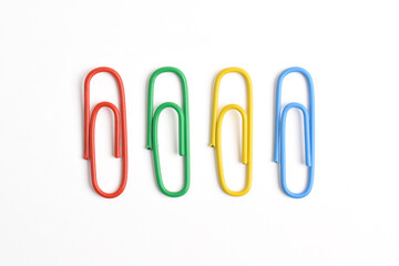 Collection of colorful paper clips isolated on white background, top view