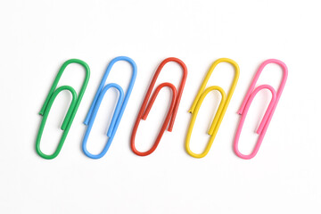 Collection of colorful paper clips isolated on white background, top view