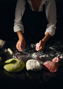 Female Chef Preparing Various Colored Pasta Dough in a Cozy Kitchen Setting