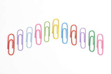 Obraz premium Collection of colorful paper clips isolated on white background, top view
