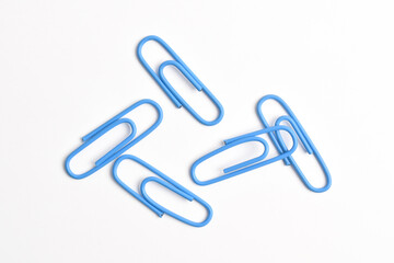 Many blue paper clips isolated on white background