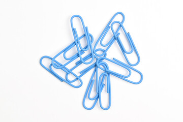 Many blue paper clips isolated on white background