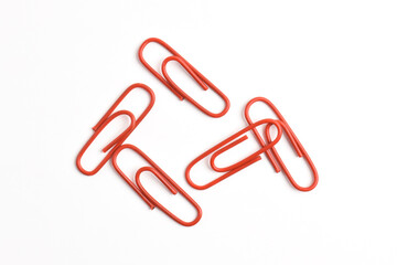 Many red paper clips isolated on white background