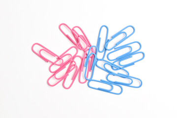 Pink and blue paper clips isolated on white background