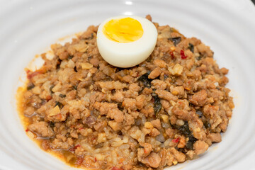 A Thai basil minced pork set meal arranged on a tray, including a portion of stir-fried spicy basil...